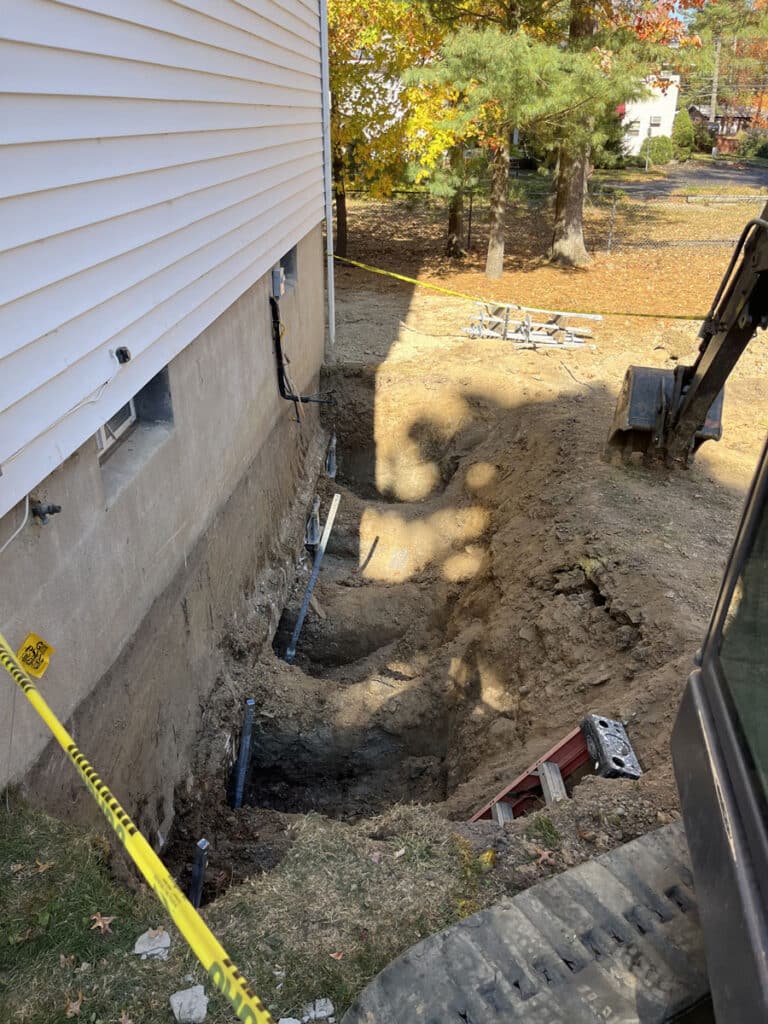 Foundation repair project using helical piles.