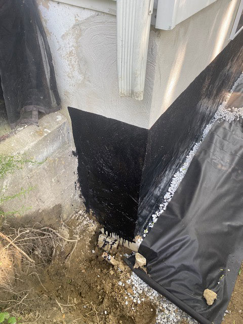 Close up of new foundation next to existing foundation.