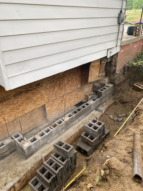 Foundation damage - showing dug up area around basement